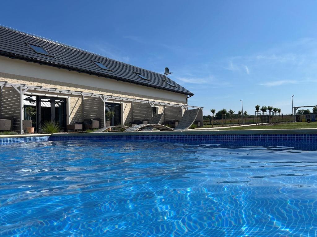 a large swimming pool in front of a building at Mamma Mia Park in Łukęcin
