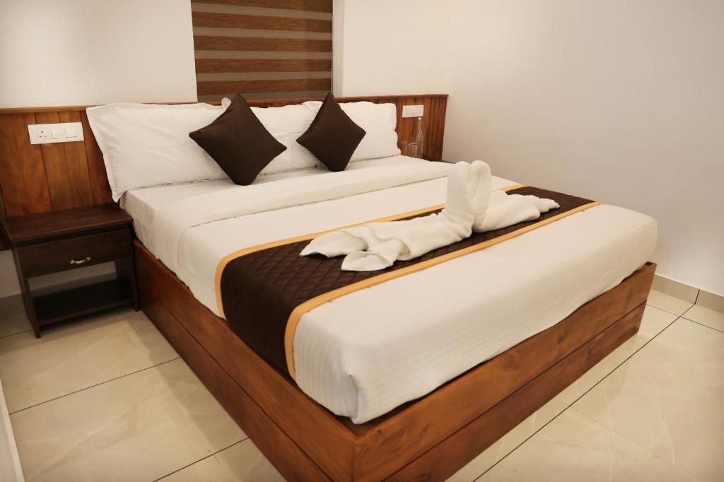 Ένα ή περισσότερα κρεβάτια σε δωμάτιο στο Thazhvaram Homestay