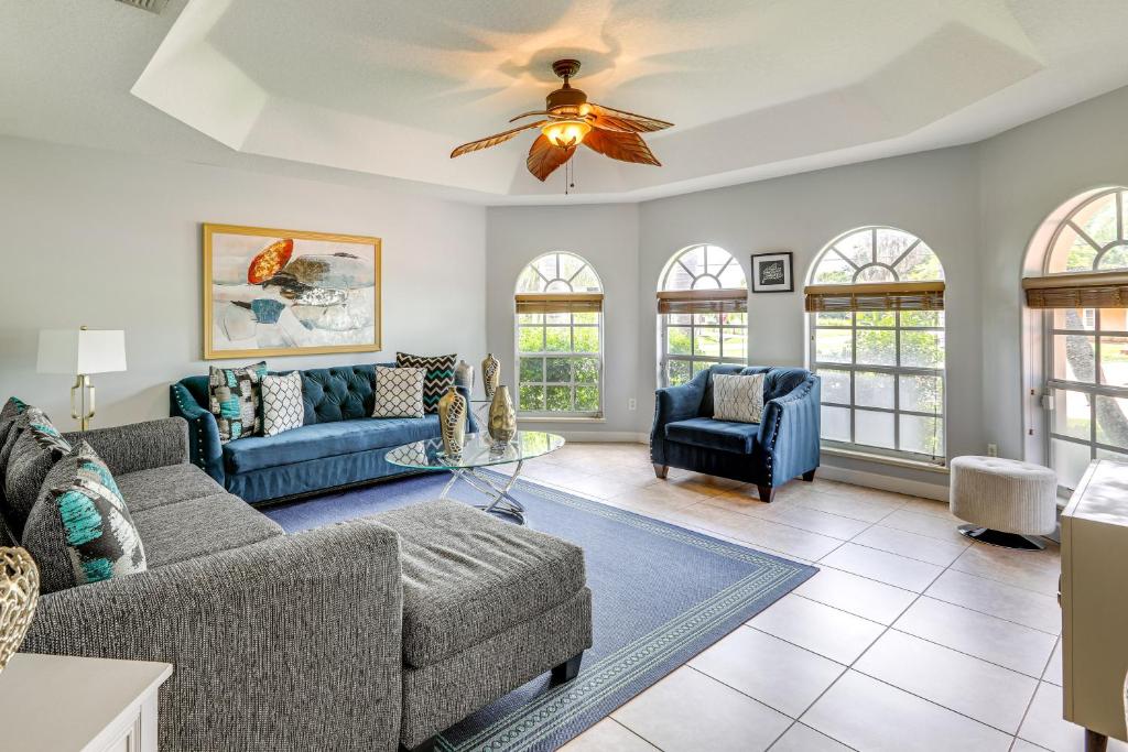 a living room with a couch and a ceiling fan at Family Home in Port St Lucie with Furnished Pergola! in Port Saint Lucie