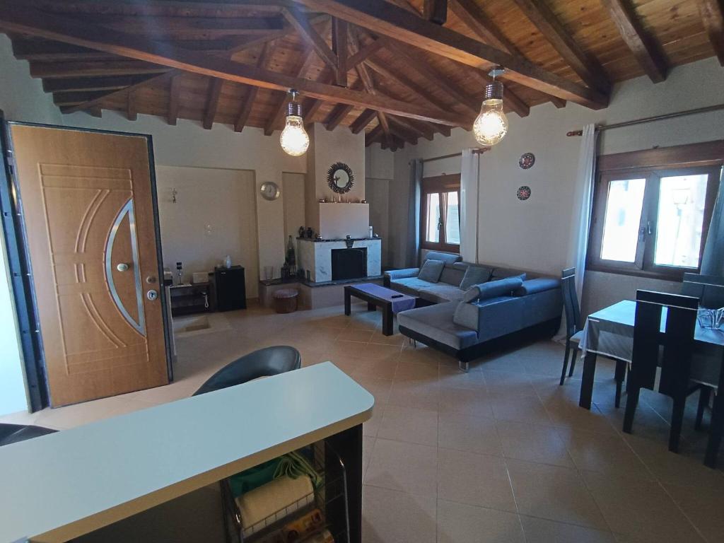 a living room with a couch and a table at The Fortress, beautiful and private house with top in Skiathos Town