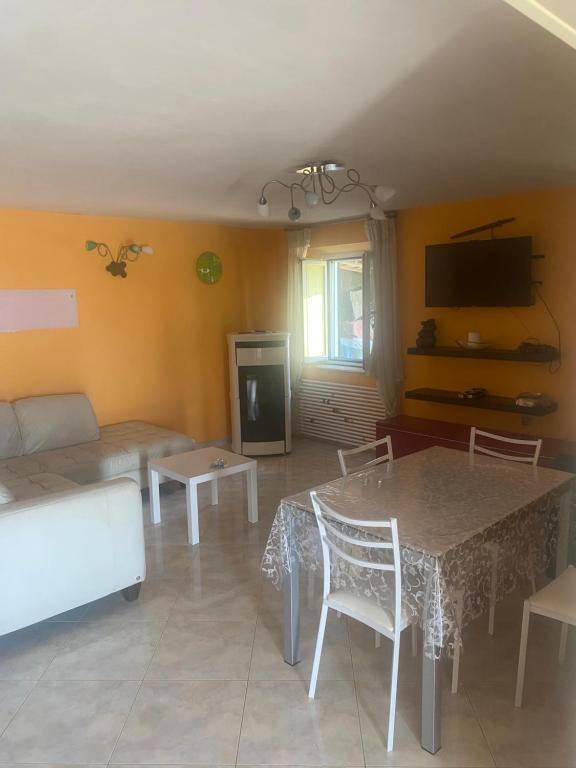 a living room with a table and a couch at Casa del mare in Cupra Marittima