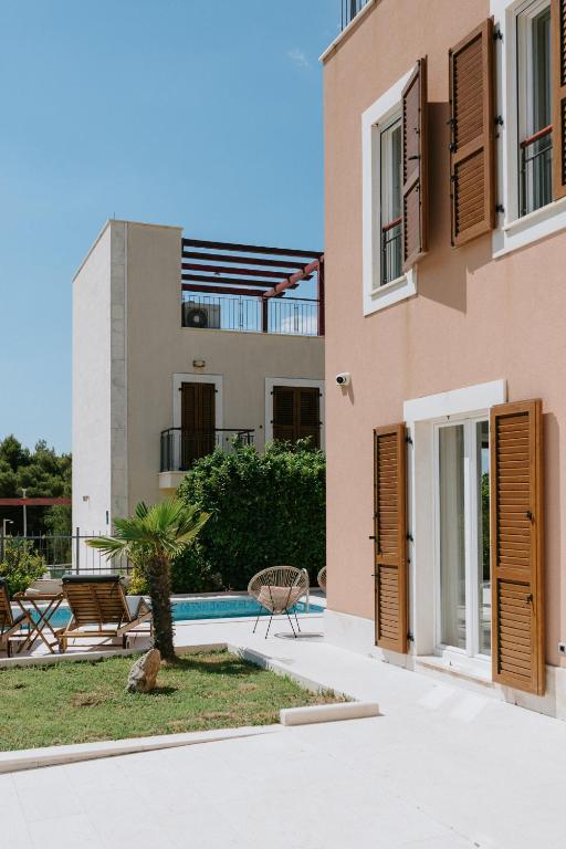 a villa with a pool and a house at Villa Melograno by Domus Mirus - Rooftop Cinema, Pool, 6-Minute Walk to Beach in Splitska