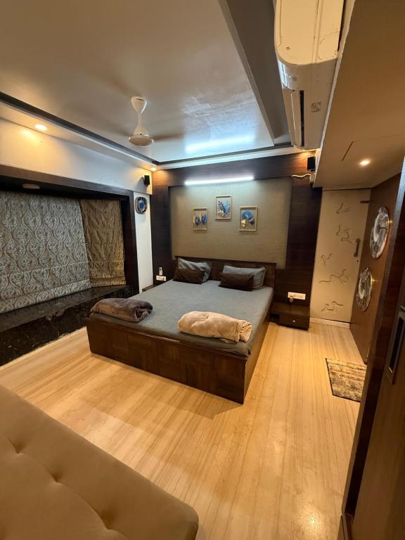 a bedroom with a large bed and a couch at Bandra’s Prime luxurious 2 BHK in Mumbai