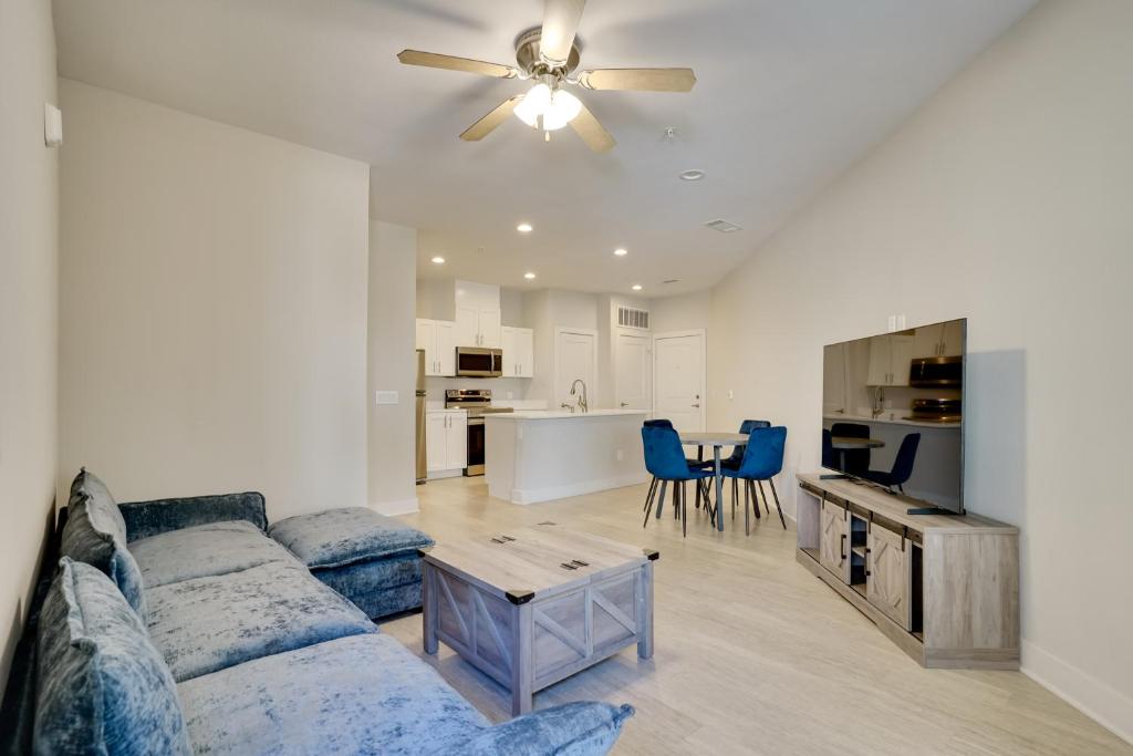 a living room with a couch and a ceiling fan at Pool Access, 1 Mi to Shops and Eats Crowley Rental in Crowley