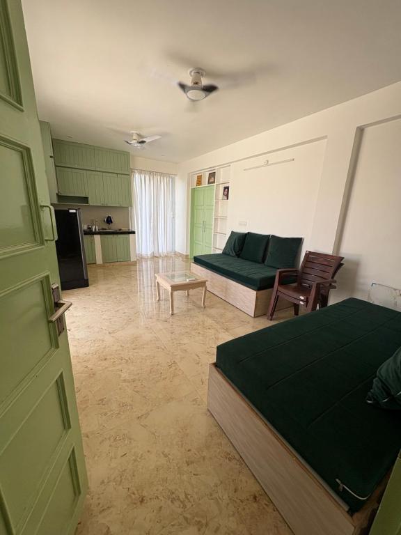 a living room with a bed and a couch at Divine Sanctuary at Radha Raman in Vrindāvan