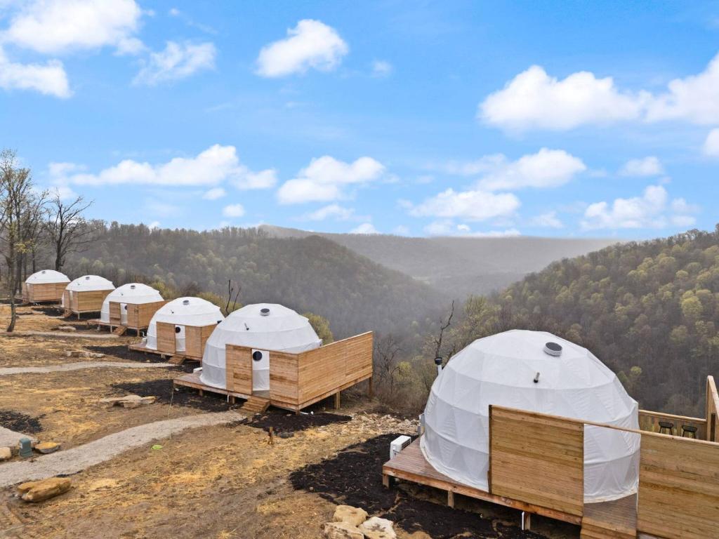 a row of white tents sitting on top of a hill at "Cloud Chaser" - The Overlook LUX Dome - RRG in Stanton