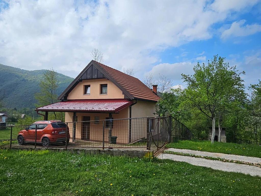 a house with a car parked in front of it at Give Peace a Chance - 10 km from Sarajevo City Center in Petrovići