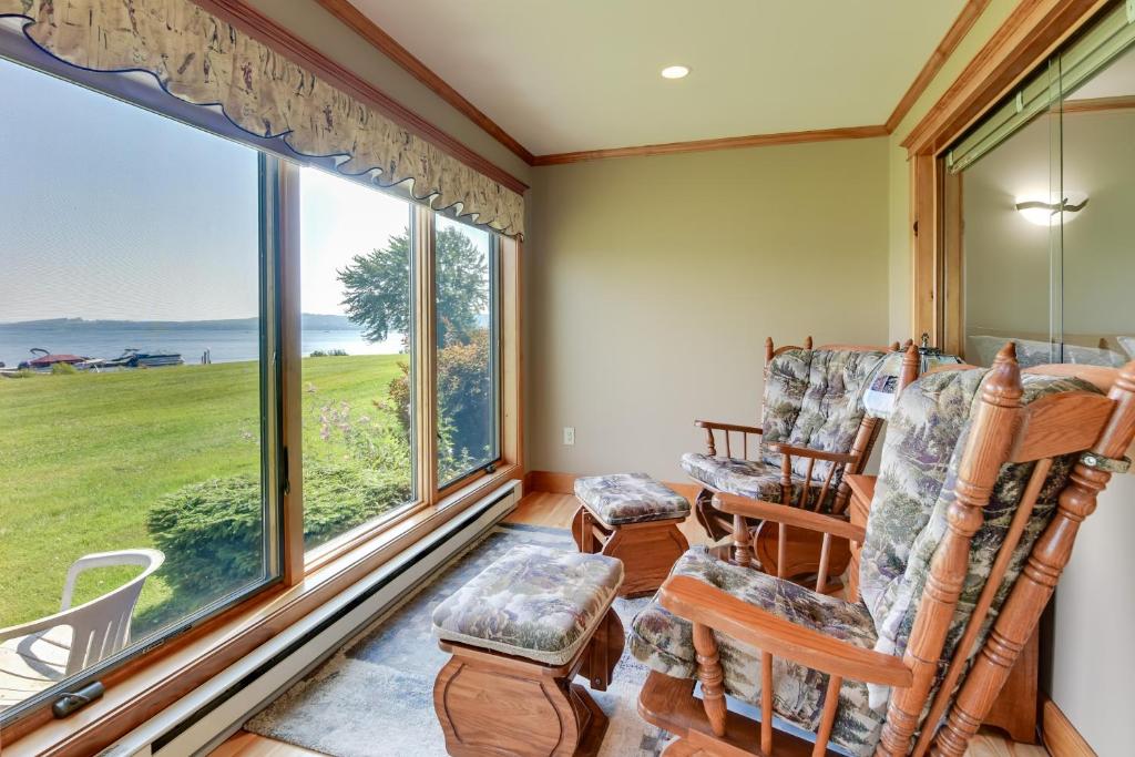 a room with two chairs and a large window at Pool Access Waterfront Lake Memphremagog Condo! in Newport