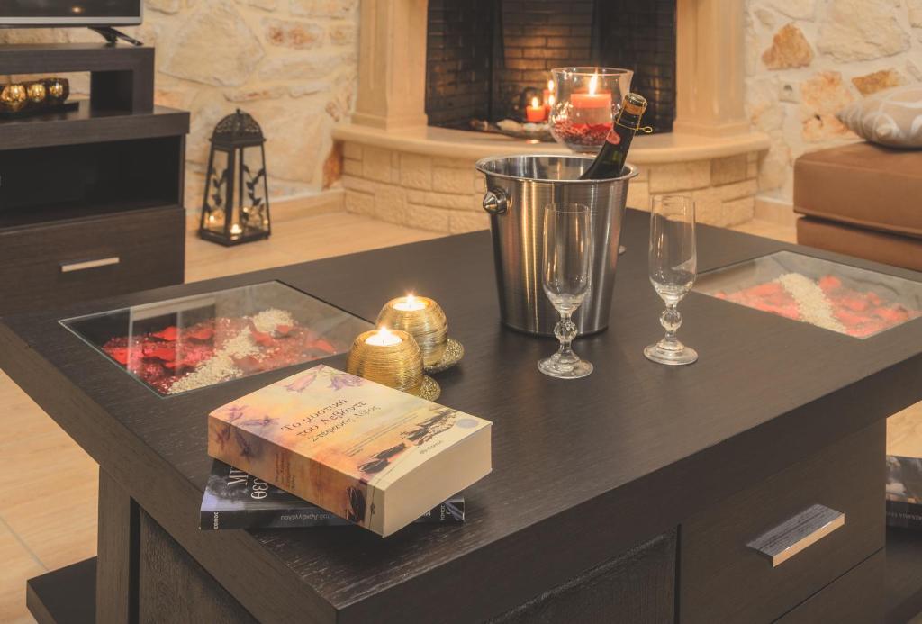 a counter with candles and a box on a table at Eden Villas in Anafonítria