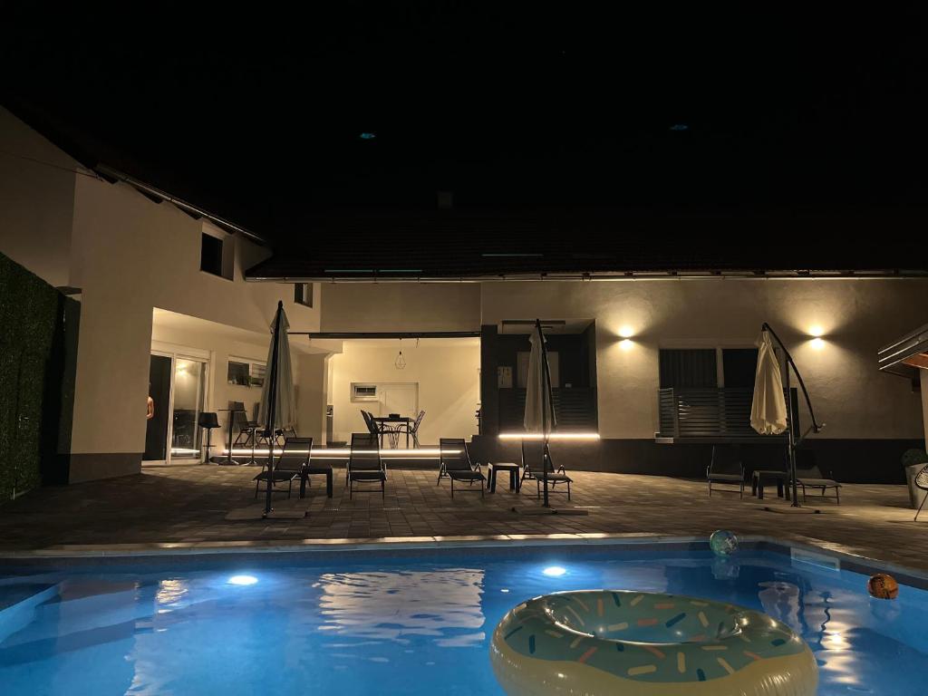 a swimming pool with a table and chairs and a patio at House Karla in Cerovac Barilovički