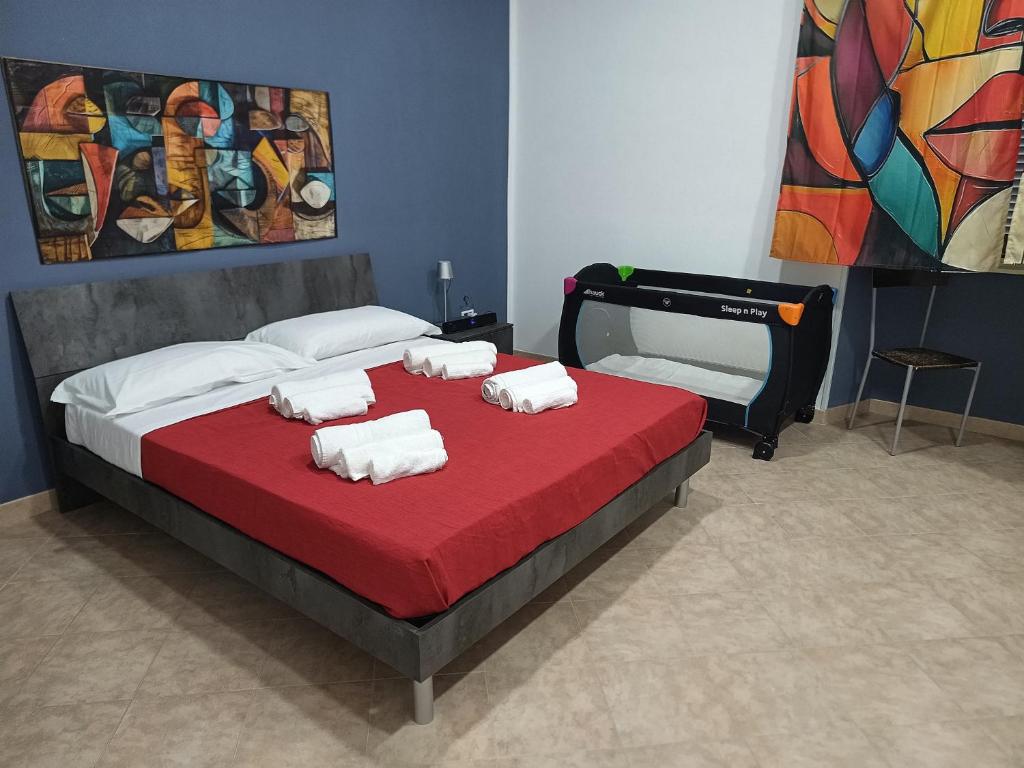 a bedroom with a bed with towels on it at Dalle ziette! in Civitavecchia