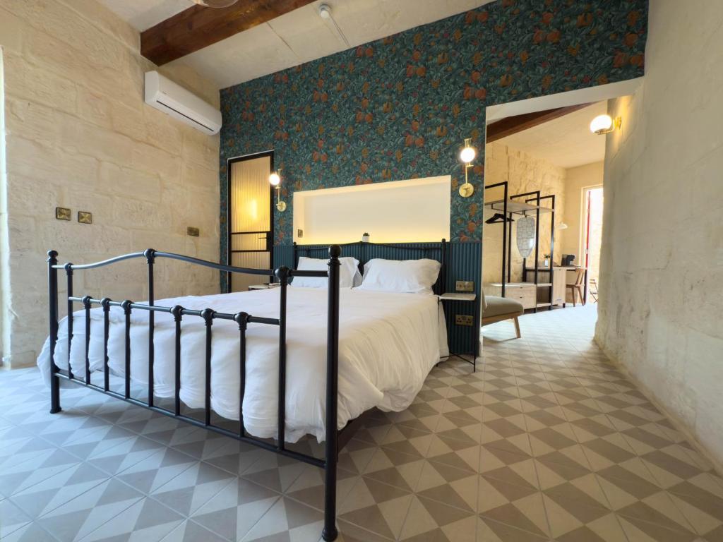 a bedroom with a bed and a large mirror at Fourteen Guesthouse in Żejtun