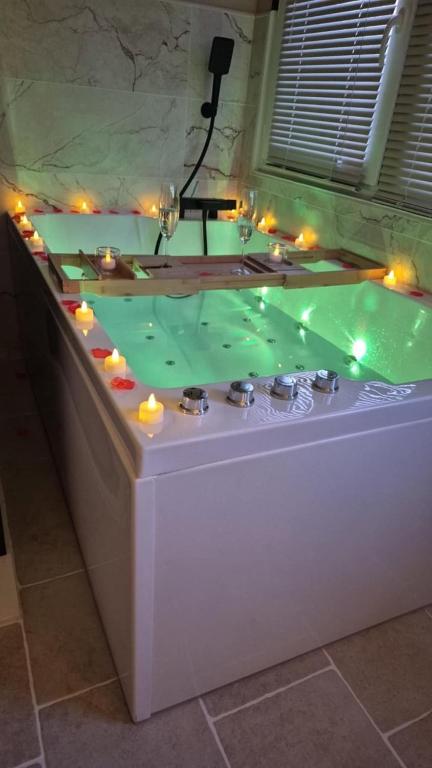 a jacuzzi tub with lights on top of it at Loveroom Eclat d emoi in Condé-sur-Noireau