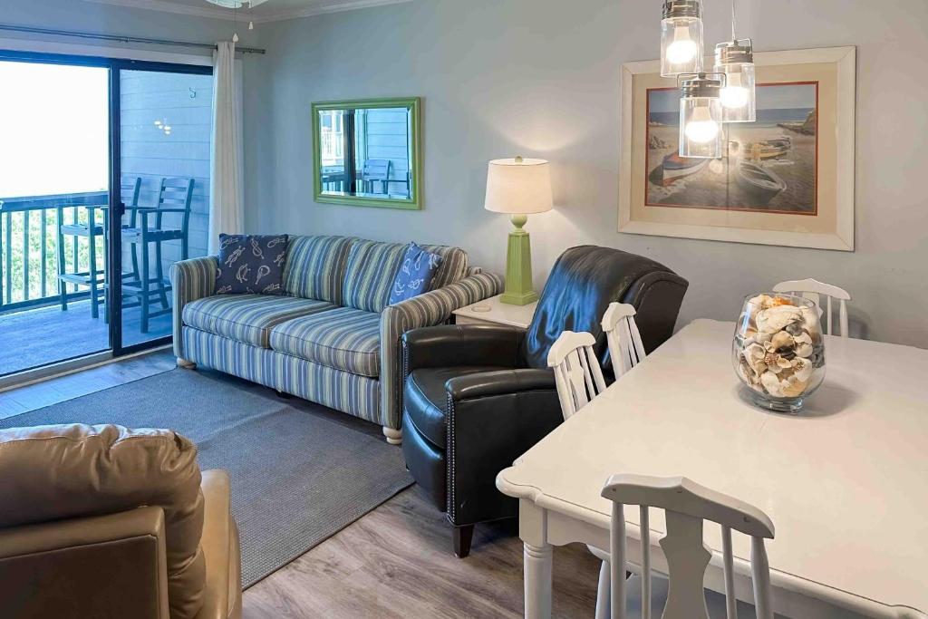 a living room with a couch and a table at Dunescape Villas 252 in Atlantic Beach