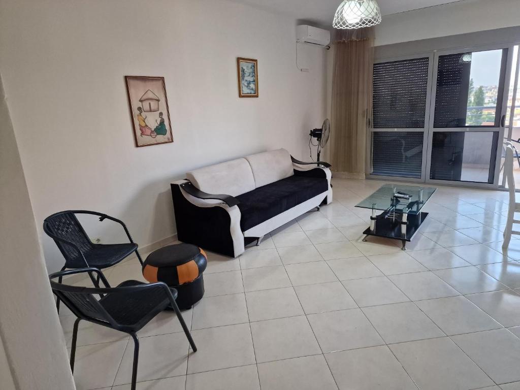 a living room with a couch and a table and chairs at DURRES SEA SIDE Big Family Apartament in Durrës