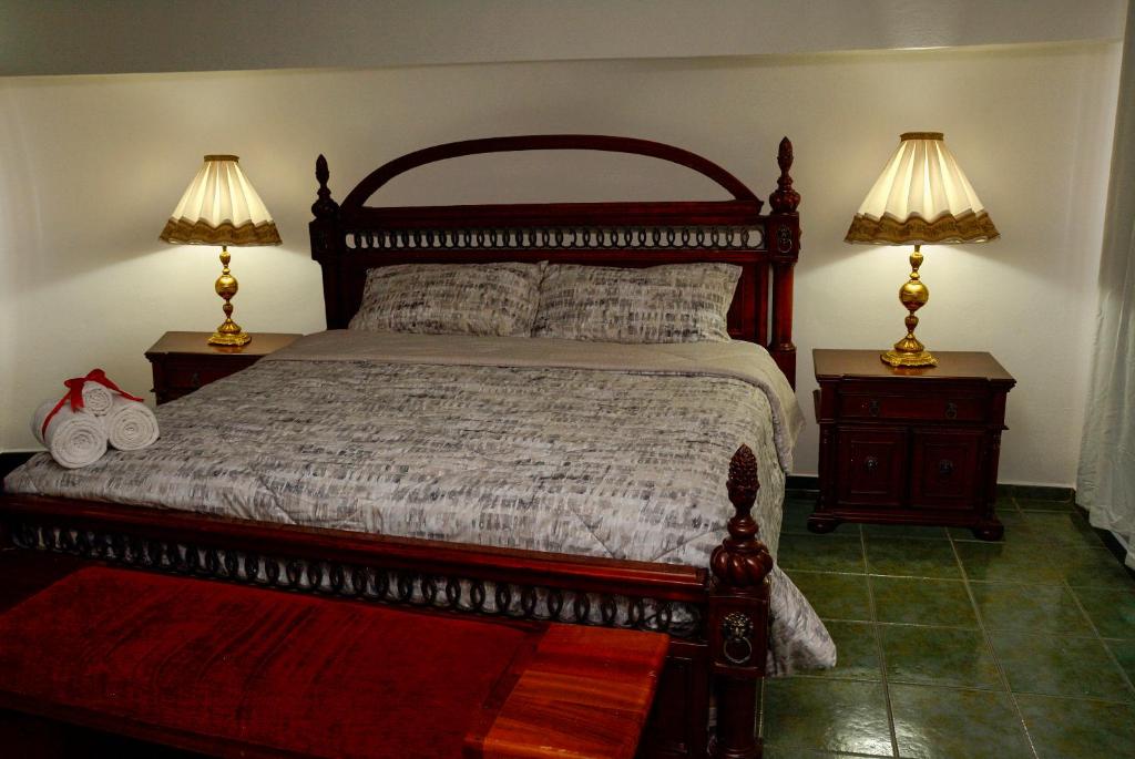 a bedroom with a large bed with two night stands at Casa Angel in Morelia