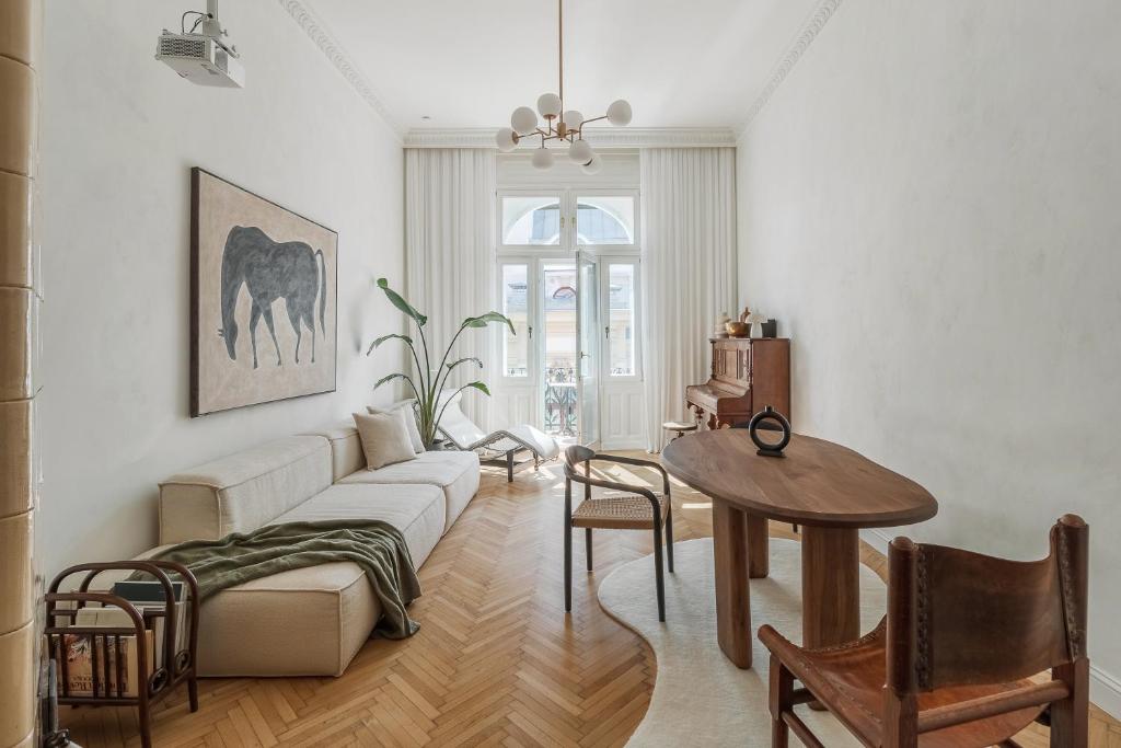 a living room with a couch and a table at Adorján Apartments - The Grand Salon in Oradea