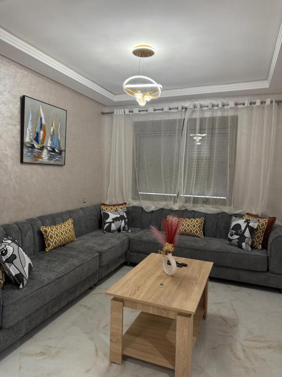 a living room with a couch and a table at trqnche 5 imm k rsd no 189 riad essalam in Tangier