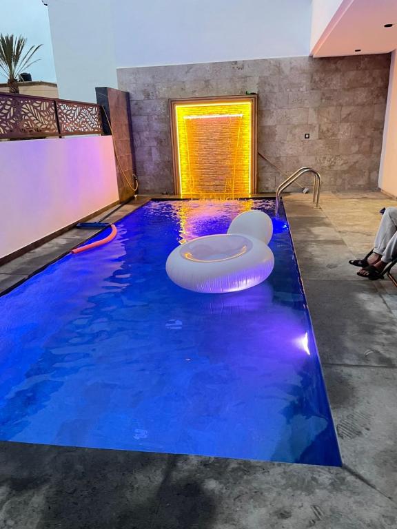 a swimming pool with blue water in a building at Beachside Bliss: Cozy Surf Villa in Mirleft