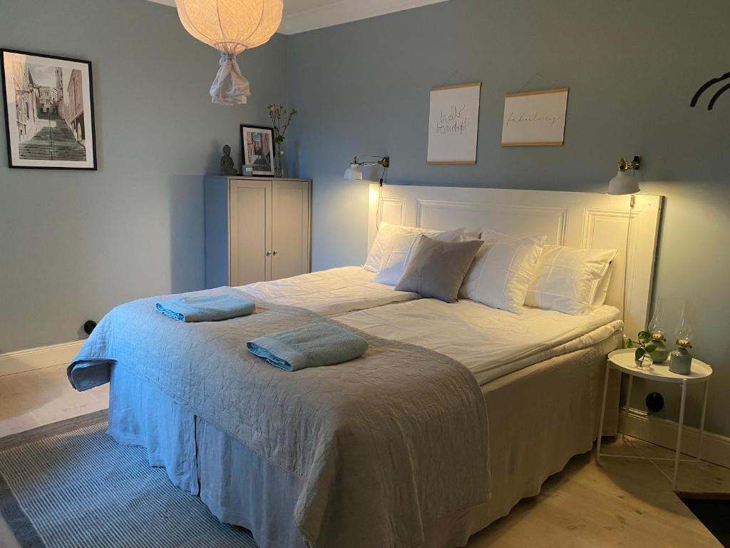 a bedroom with a large white bed with two pillows at The Green House in Norrtälje
