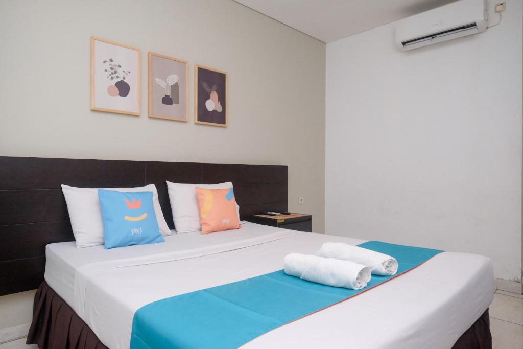 Una cama o camas en una habitación de Sans Hotel Prime Cailendra Yogyakarta by RedDoorz