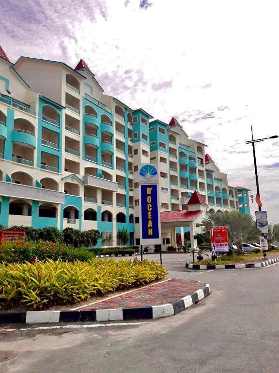 a large building with a sign in front of it at Homestay Marina in Lumut