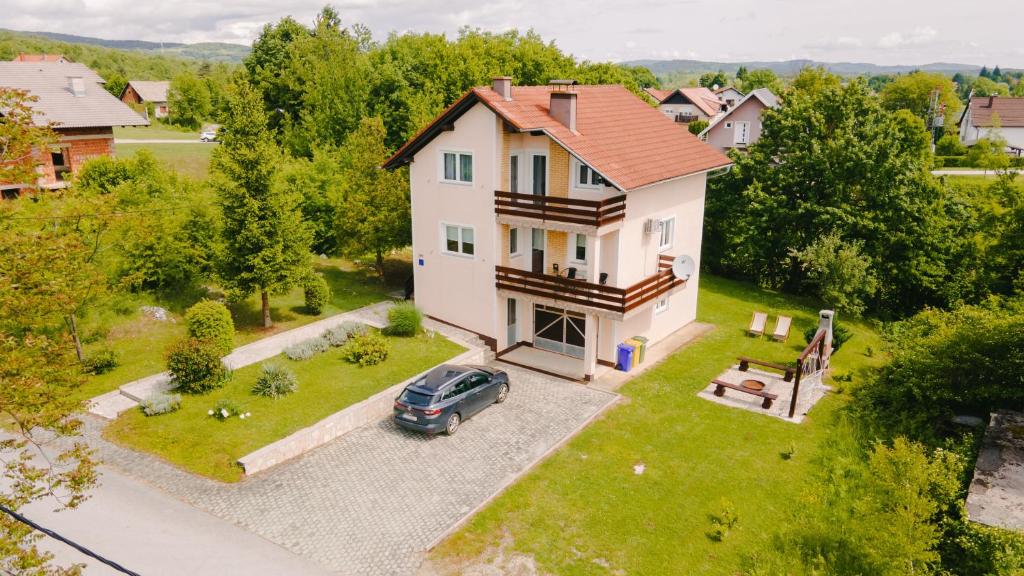 an aerial view of a house with a car parked in the driveway at Holiday house with a parking space Grabovac, Plitvice - 21998 in Rakovica