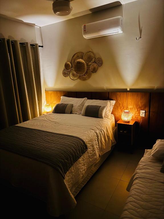 a bedroom with a large bed in a room at Chalé Paraíso Santo Amaro in Santo Amaro