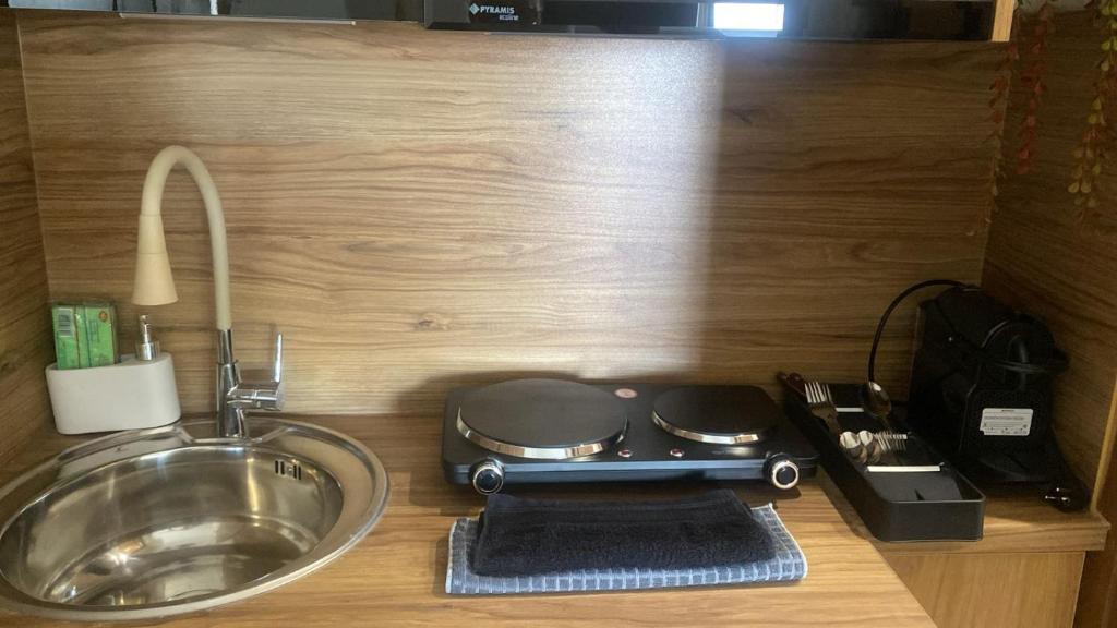 a kitchen counter with a stove and a sink at Central D1 City Apartment in Volos