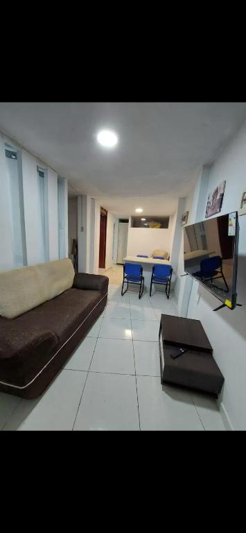 un salon avec un canapé et une table dans l'établissement Pequeño Departamento, à Los Blancos