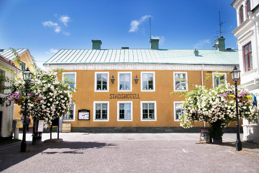 a large orange building with flowers in front of it at Trosa Stadshotell & Spa in Trosa