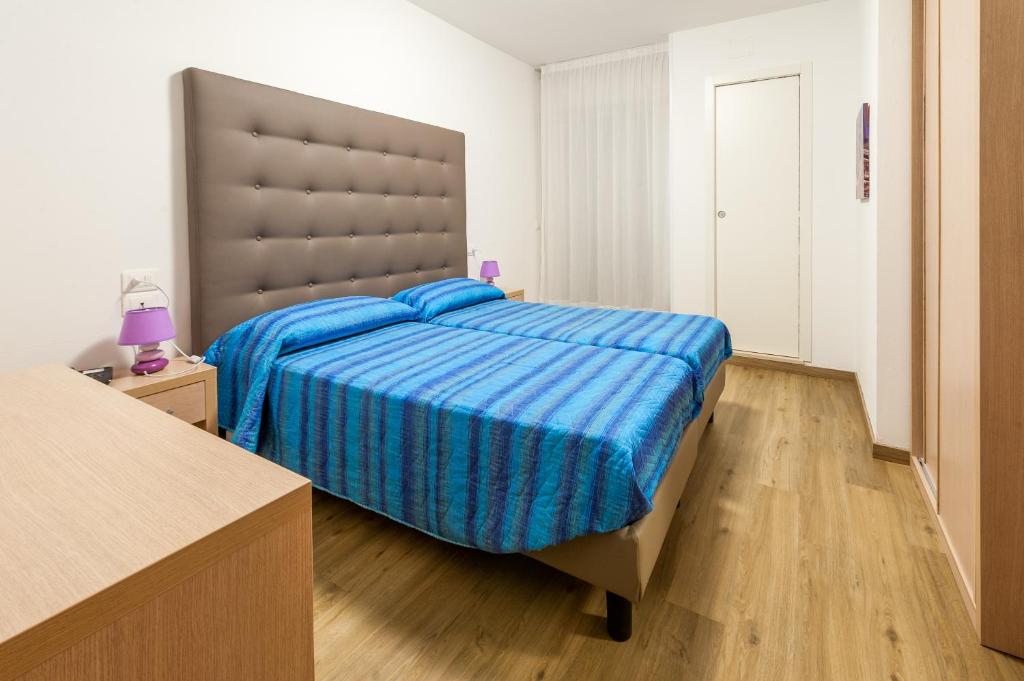 Postel nebo postele na pokoji v ubytování Hotel Garni Losanna