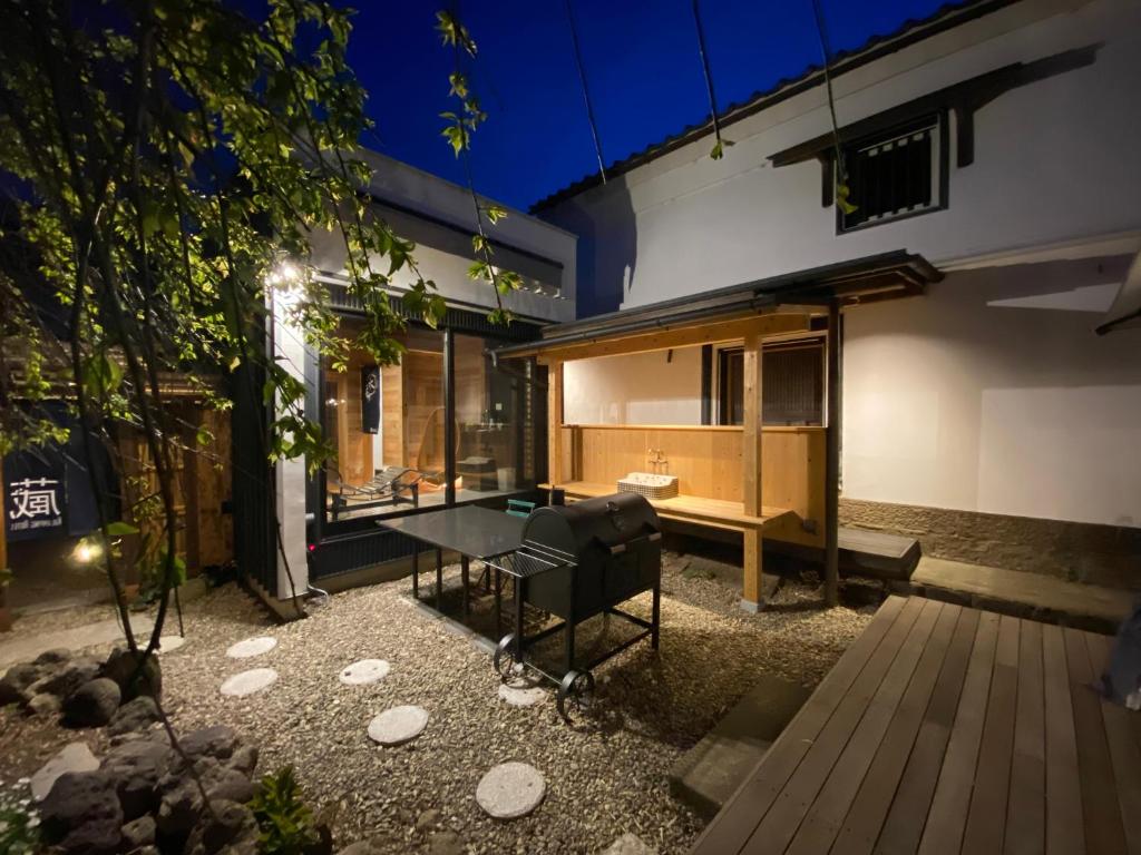 a house with a ping pong table in the backyard at 蔵Mping Hotel in Fukaya