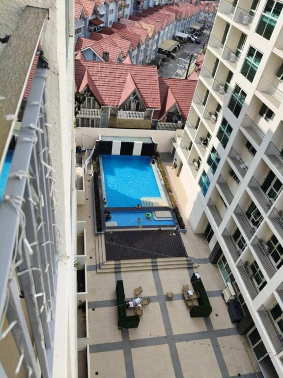 an overhead view of a swimming pool between two buildings at 1BR Condo near Tourist Spots in Baguio