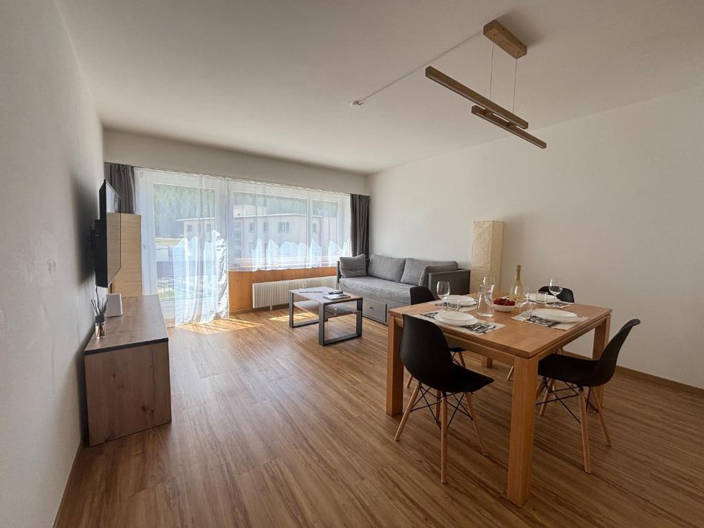 a living room with a table and a couch at Chesa in Selva in St. Moritz