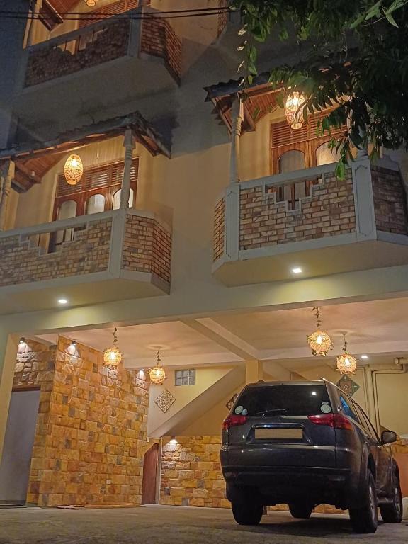 a black car parked in front of a building at PearlDrop Hills Kandy in Kandy