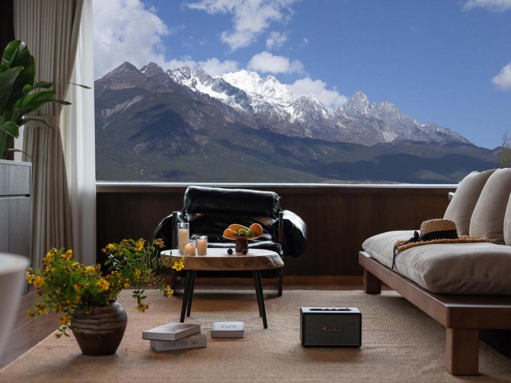 un soggiorno con vista sulle montagne di Qíng Shān Yuè Panorama Design Resort Villa Jade Dragon White Sand Lijiang a Baisha