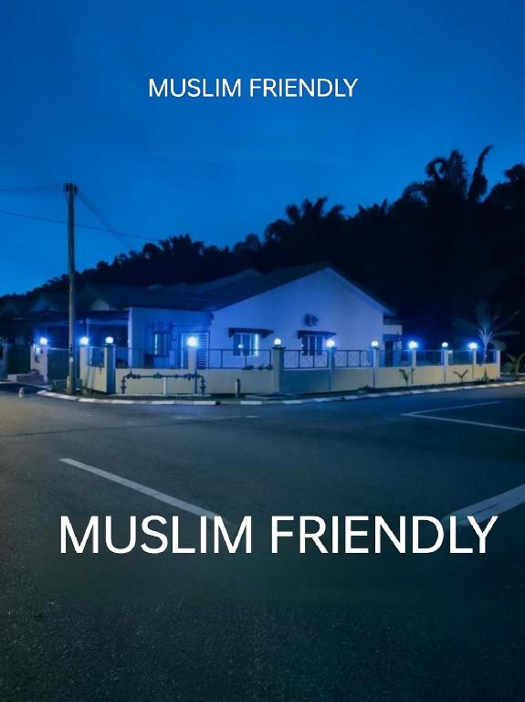a night view of a house with the words muslin friendship at Swedish Style Homestay in Teluk Intan