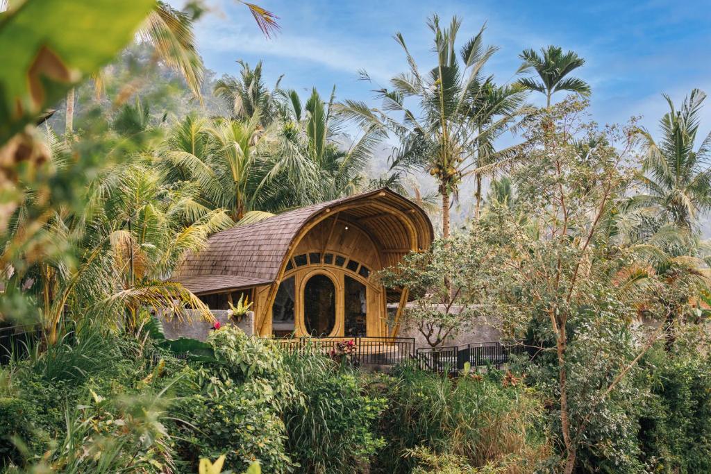 a small house in the middle of a forest at Aura Cendana Hill Sidemen in Selat