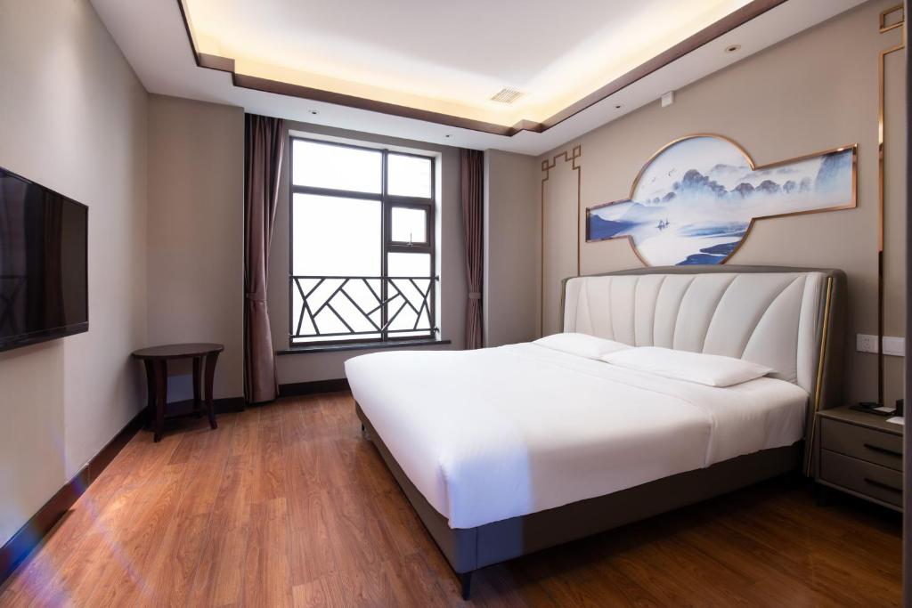 Krevet ili kreveti u jedinici u okviru objekta Wuhan Hongguang Hotel