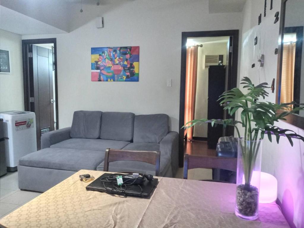 a living room with a couch and a table at Condo staycation in SLP Bangkal Makati in Manila