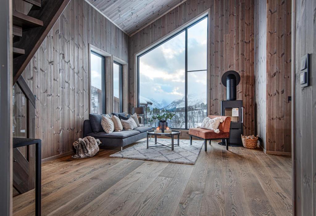 a living room with a couch and a table at 7 Min to Fjord - Alpine Stay in Stranda in Stranda
