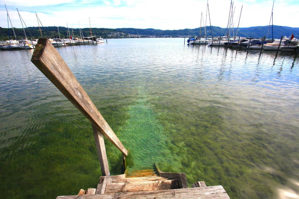 a wooden boat in a body of water with boats at Sinfonie in Bodman-Ludwigshafen