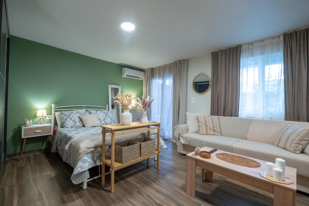 a living room with a bed and a couch at Boho Nest in Glyfada by ΜΡS in Athens
