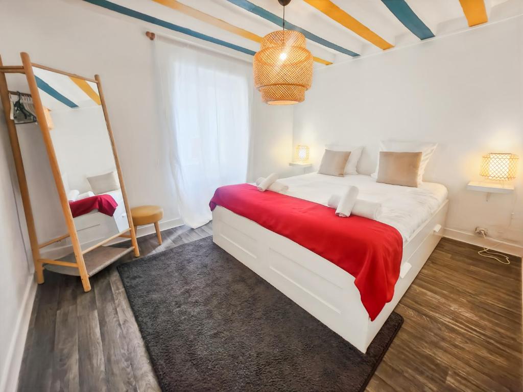 a bedroom with a large bed with a red blanket at Confort et Calme Proche Disney et Val d'Europe in Coupvray