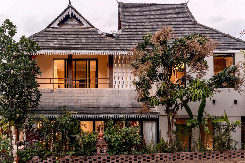 a house with a shingled roof at M ORIGINAL VILLA in Jinghong