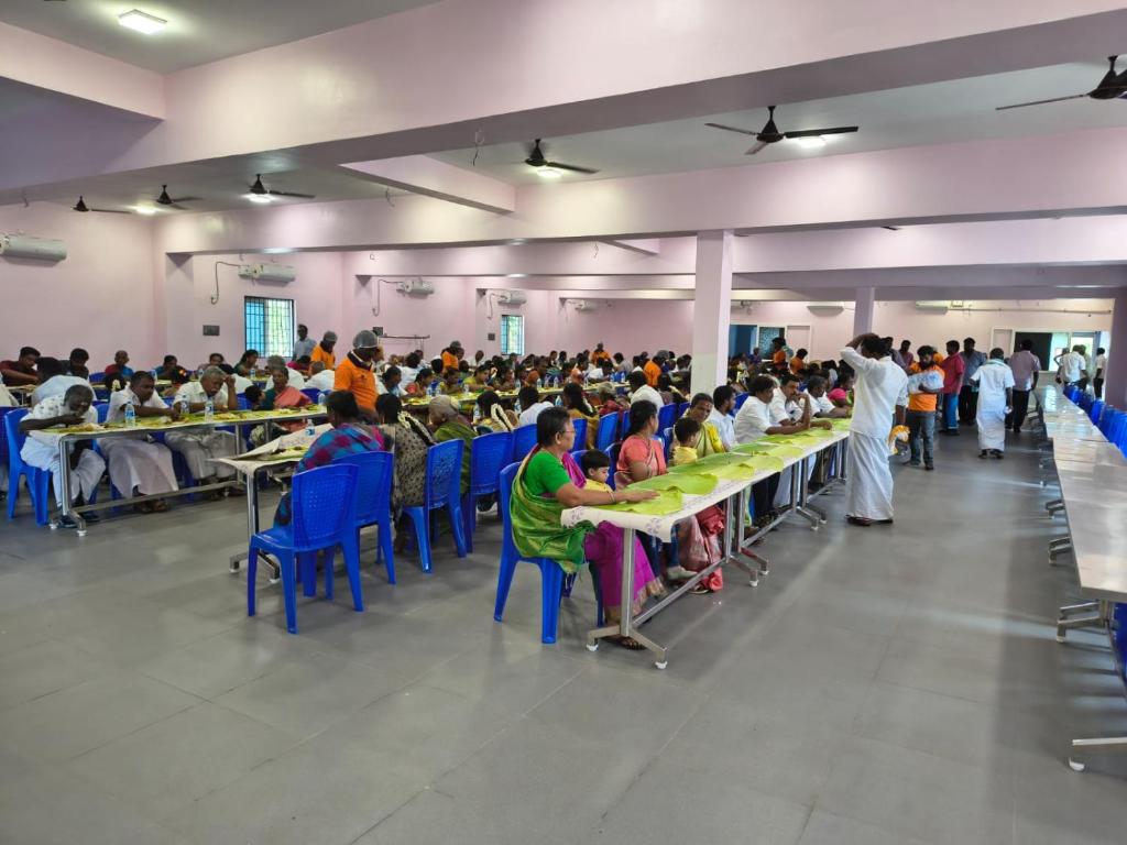 a large group of people sitting at tables in a room at DS Mahal in Pasumalai