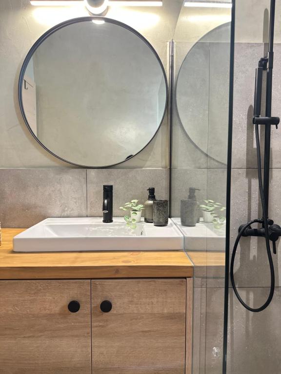 a bathroom with a sink and a mirror at 2 Doors- Luxury by the sea, easy parking in Kavala