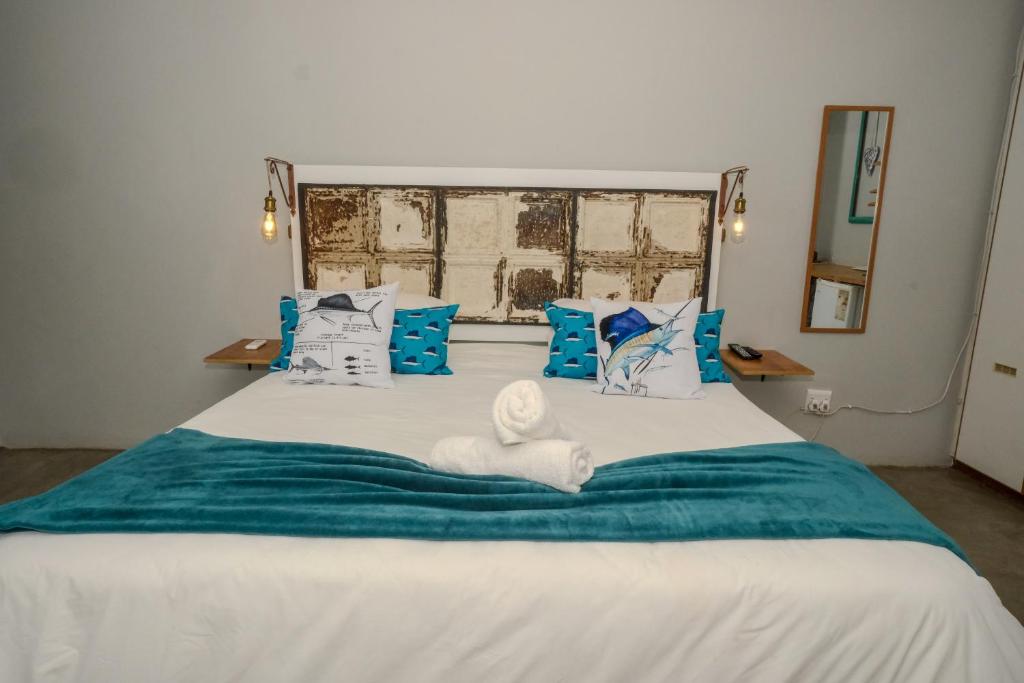 a bedroom with a bed with a towel on it at Marlin Lodge St Lucia in St Lucia