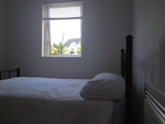 a bedroom with a bed and a window at Galway City Self Catering - Salthill in Galway